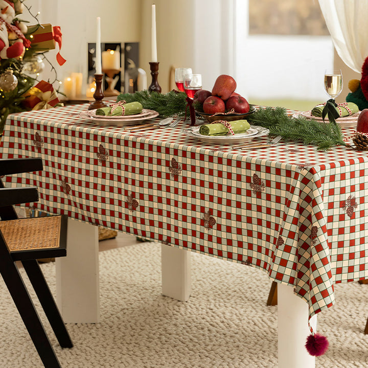 Rectangular decorative tablecloth with checkered pattern, pompom trim, and fine embroidered applique