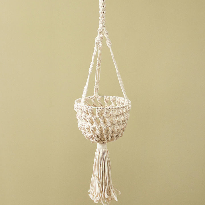 Macramé hanging planter with hand-knotted basket structure and decorative tassel