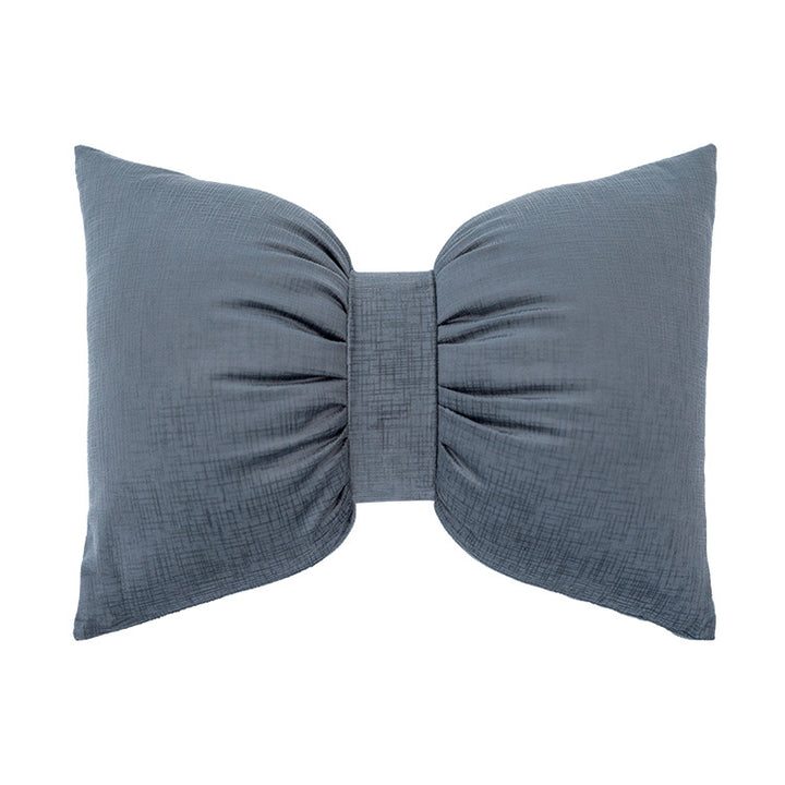 Bow-shaped decorative cushion with central band detail and structured fabric look