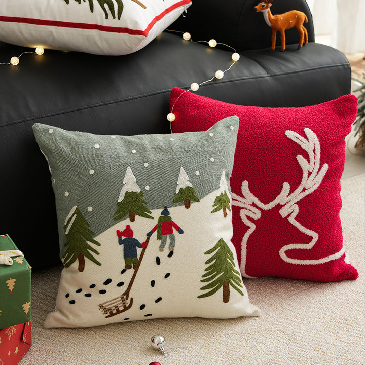 Hand-stitched winter decorative sofa cushion with sled and fir motif