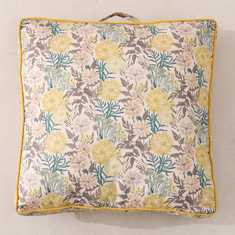 Large square floor cushion with floral cotton cover, piping, and carrying handle
