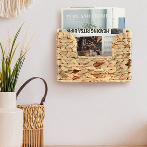 Wall shelf made of untreated wood with rattan inserts