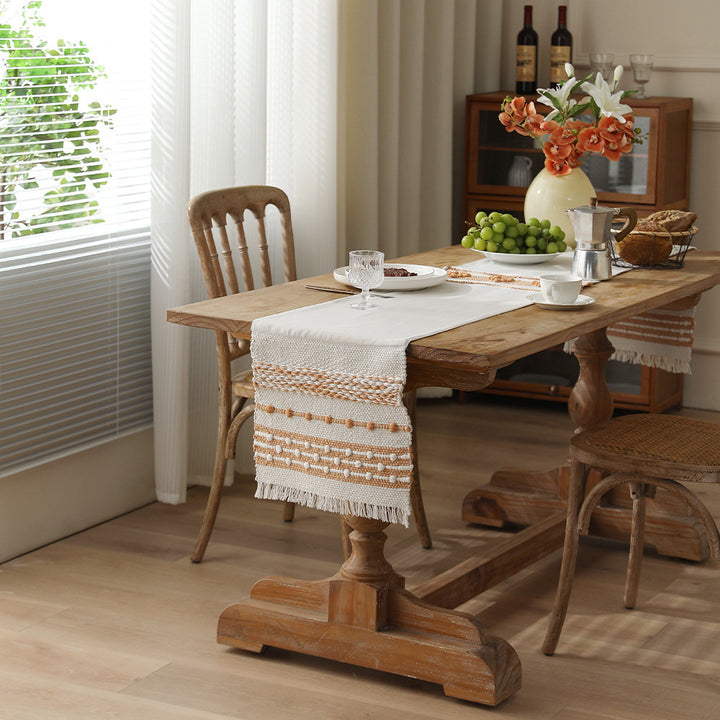 Woven cotton table runner with fringes and textured pattern