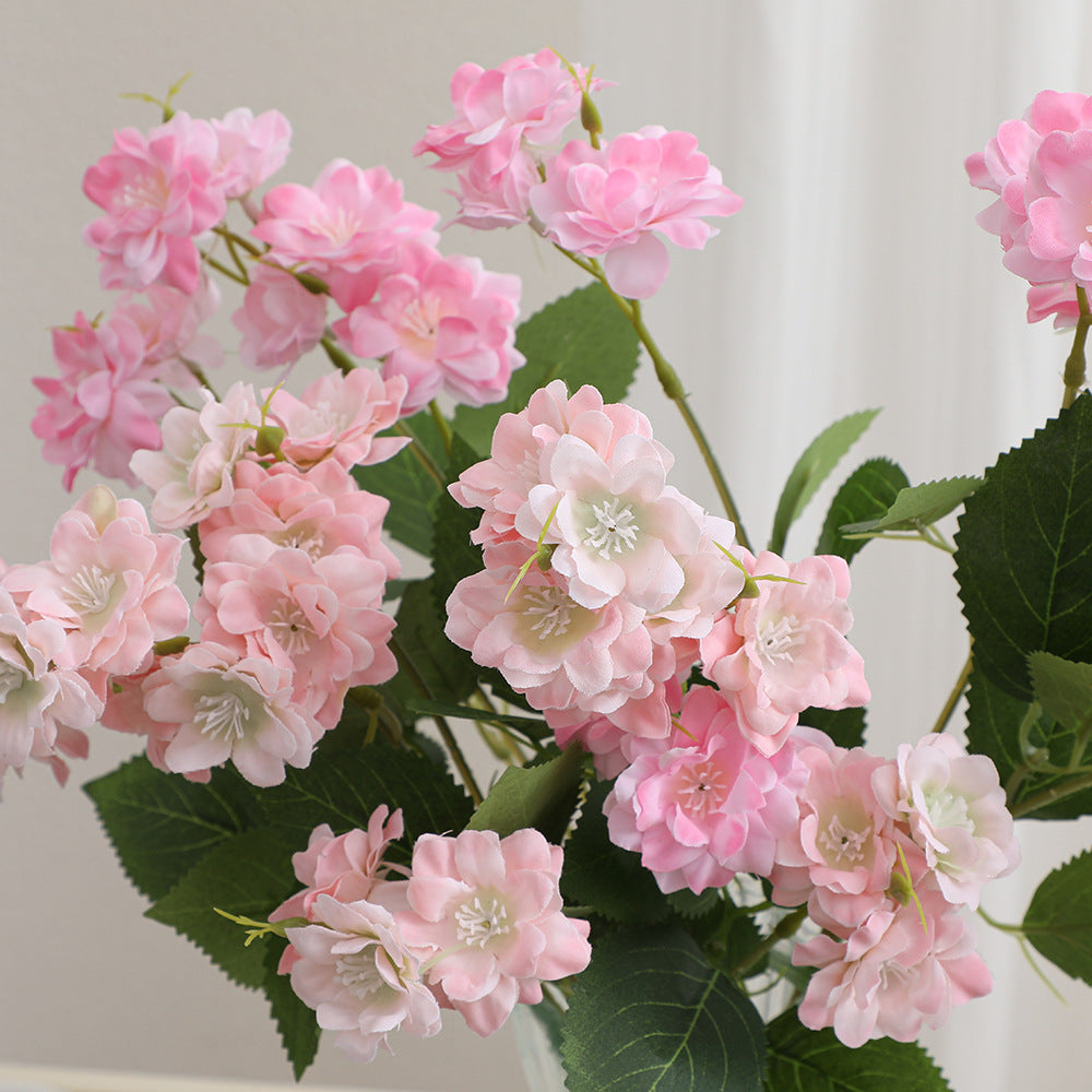 Artificial flower arrangement with delicate white blooms
