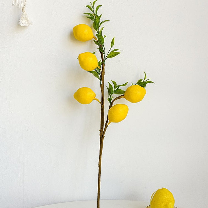 Decorative branch with artificial lemons