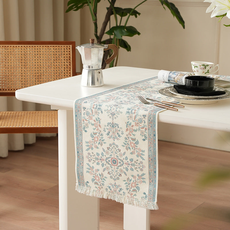 Woven jacquard table runner with floral medallion and fringes