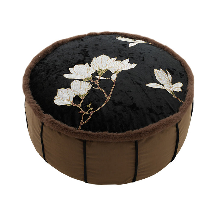 Round upholstered velvet floor cushion pouf with faux fur trim and handle