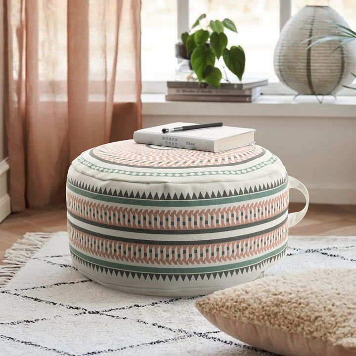 Round padded floor seat pouf with woven ethnic pattern and carrying handle