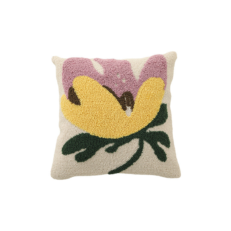 Hand-tufted decorative cushion with abstract graphic design and textured cotton surface