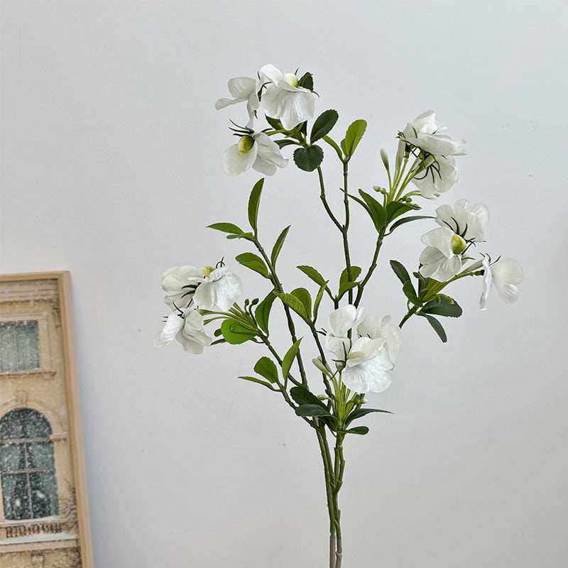Artificial flower branch with vibrant pink flowers