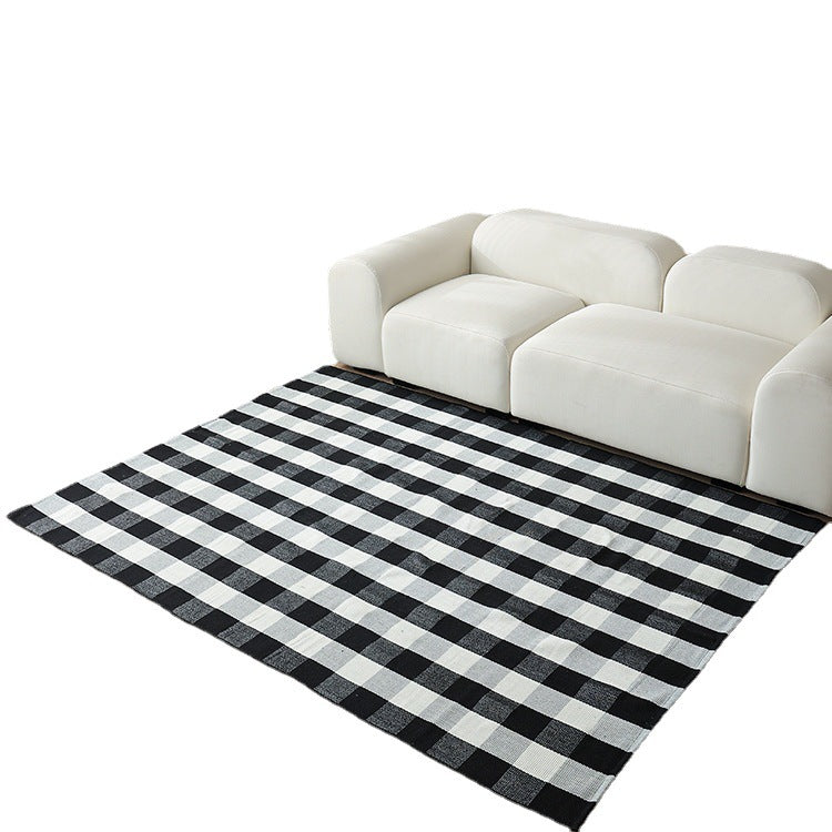 Woven living area rug with large check pattern and flat cotton texture
