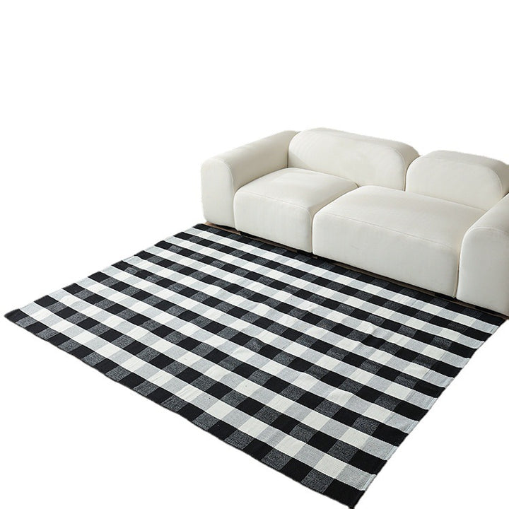 Woven living area rug with large check pattern and flat cotton texture