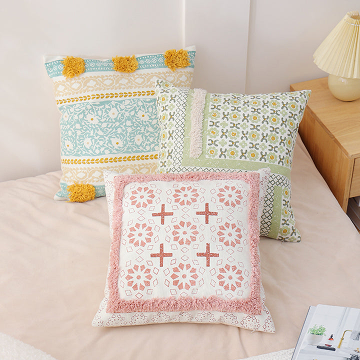 Woven decorative pillow with botanical jacquard pattern and pom-pom trim