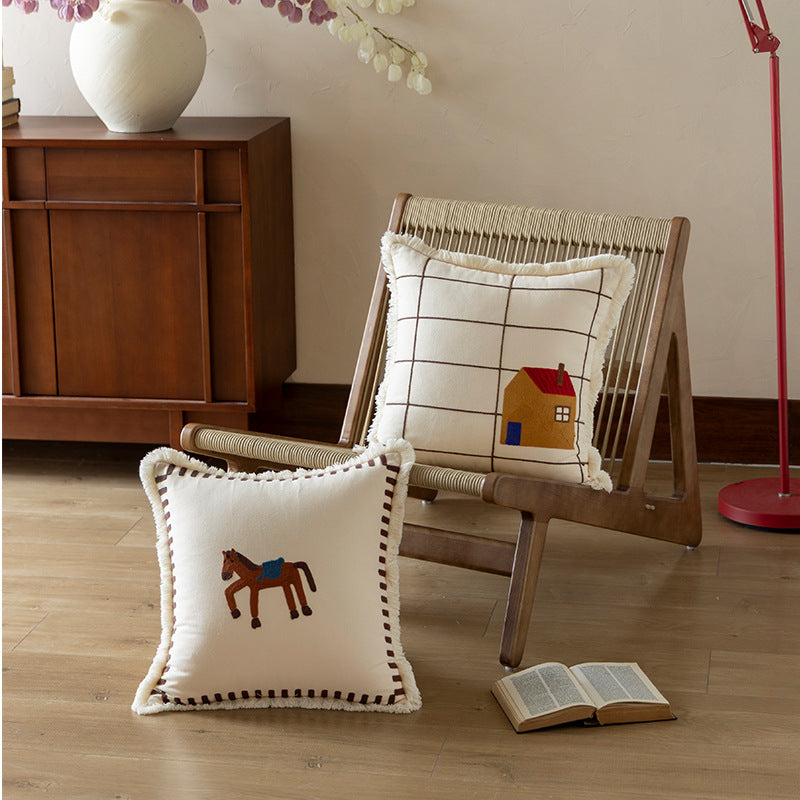 Decorative cushion cover made of cotton blend with fringes, check pattern and embroidered house