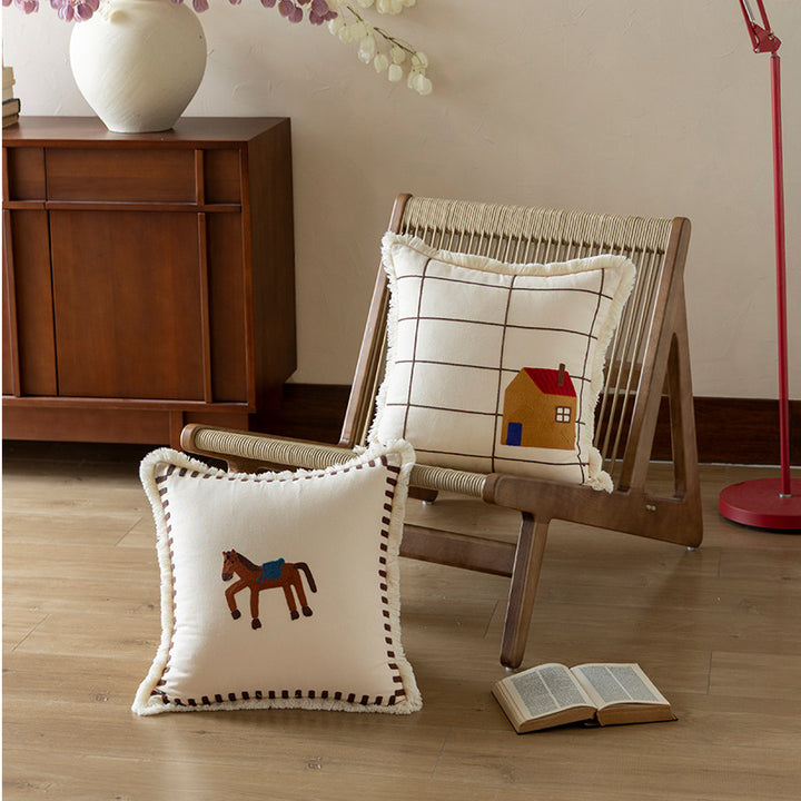 Decorative cushion cover made of cotton blend with fringes, check pattern and embroidered house