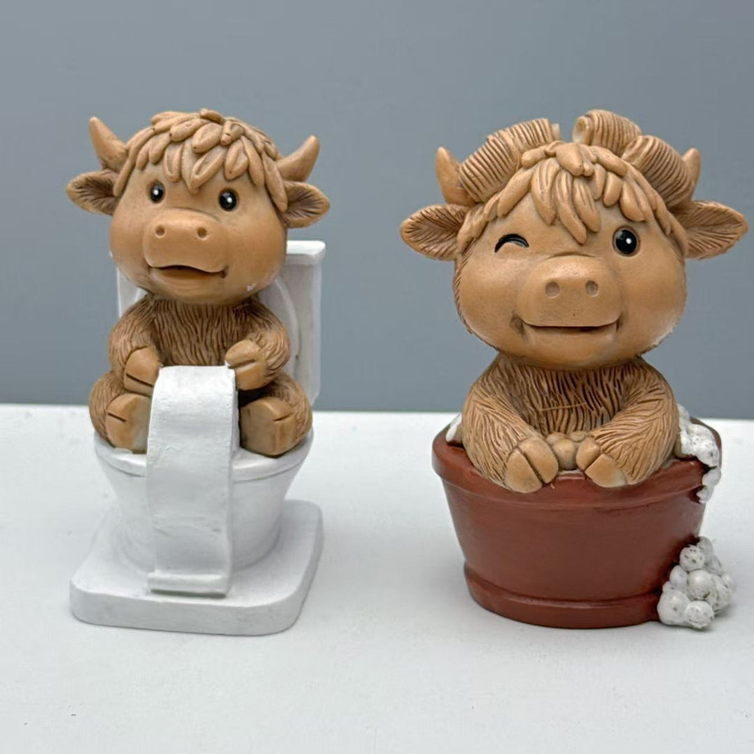 Funny decorative figure of a Highland cow on toilet