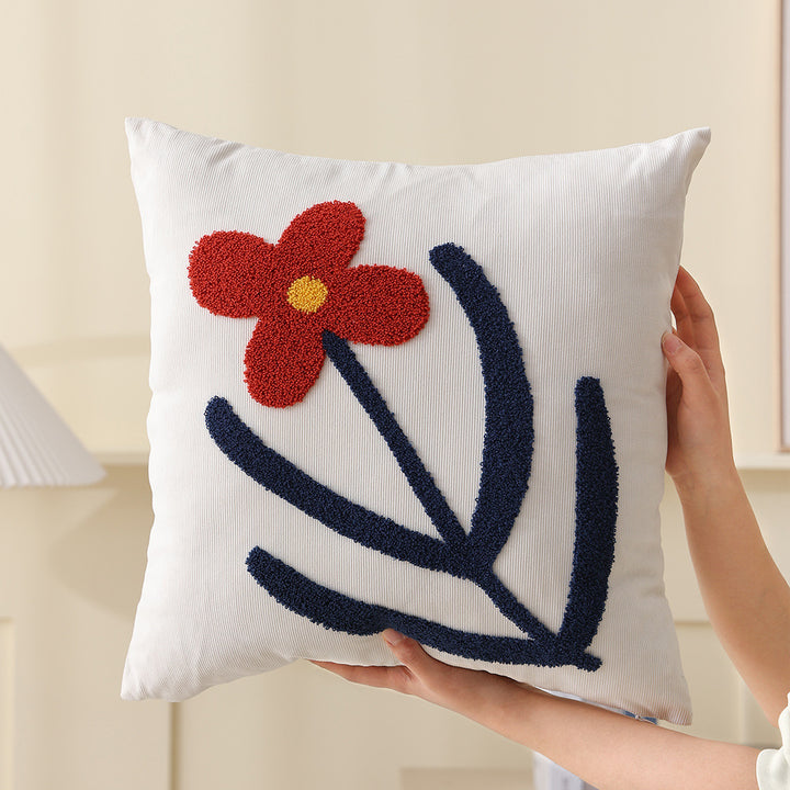Square decorative cushion with hand-tufted heart ornament and contrasting border