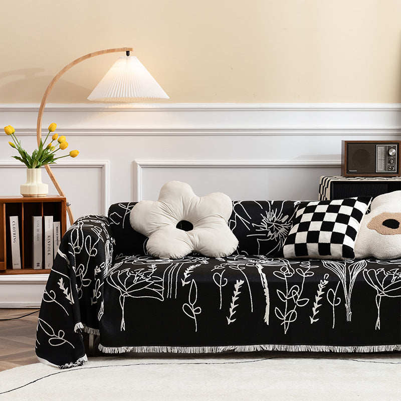 Fine woven sofa cover and furniture throw with floral line drawing and decorative fringed edge
