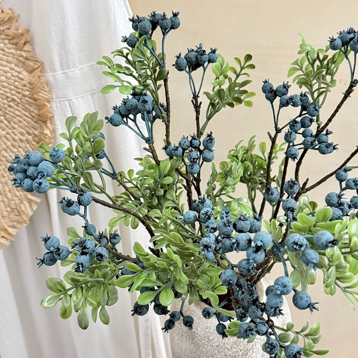 Artificial branch with glowing berries and green