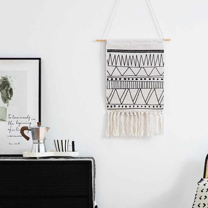 Woven Boho wall hanging with fringes and graphic ethnic pattern