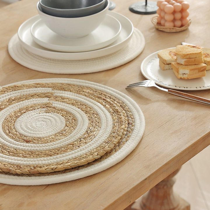 Braided round table mat made of cotton rope and sea grass with spiral structure