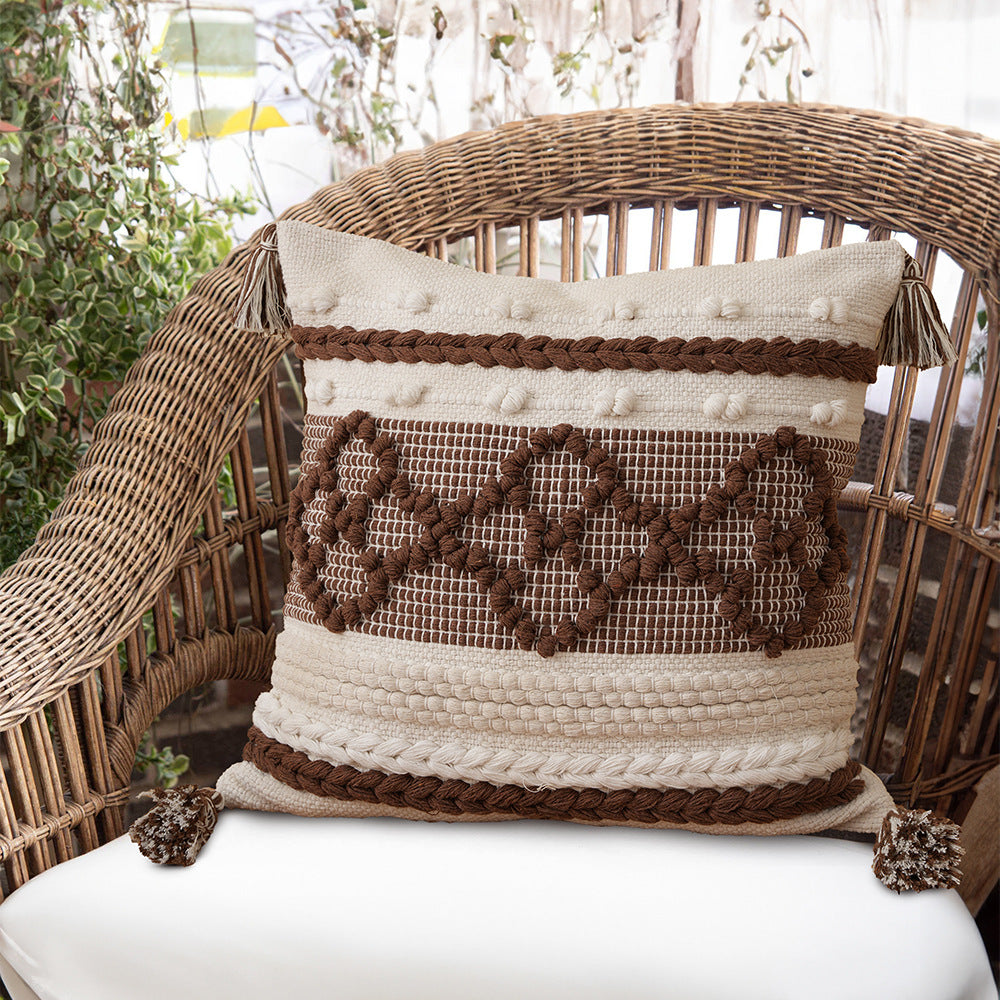 Structured decorative pillow with tufted diamonds, relief border, and corner tassels