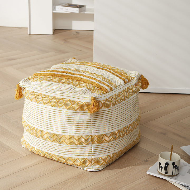 Braided square floor seat pouf with tassels and woven ethnic pattern