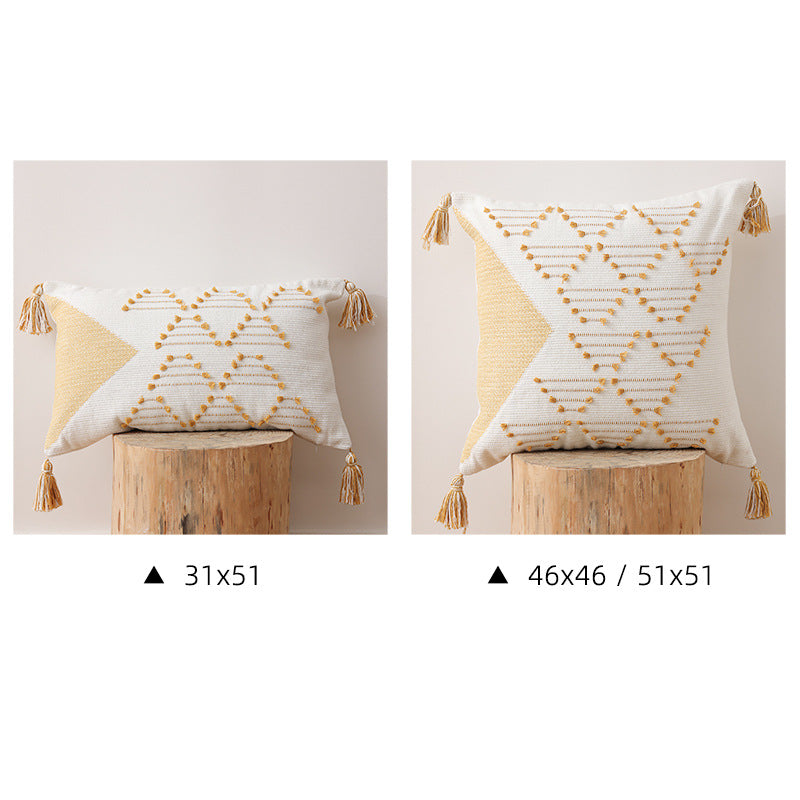 Decorative woven cushion cover with geometric tuft-relief and tassels