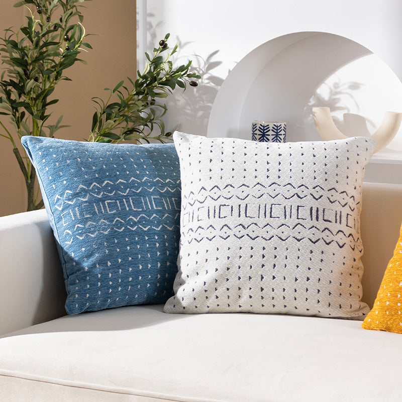 Woven pillow cover with geometric ethnic relief and textured tufting look