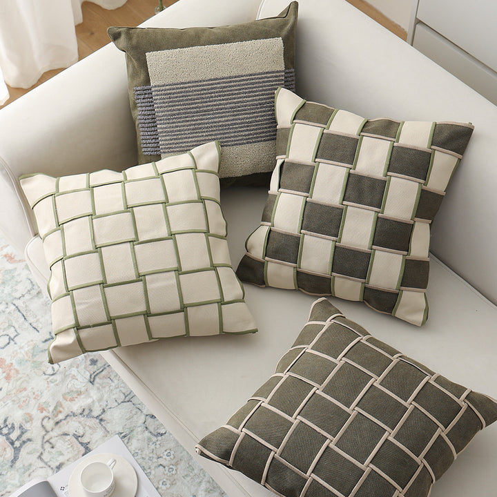 Decorative cushion cover with woven grid relief and contrasting piping