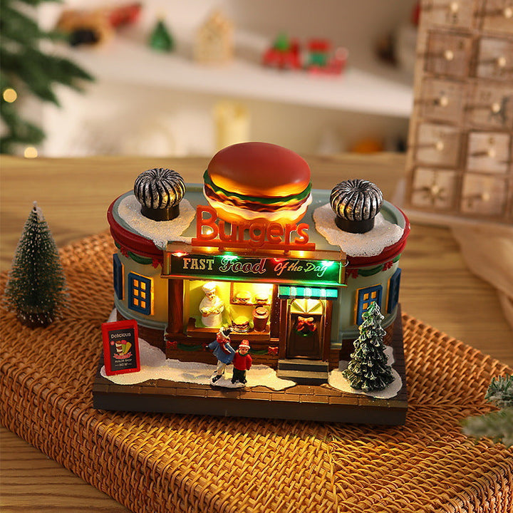 Illuminated Christmas village decoration with moving figures