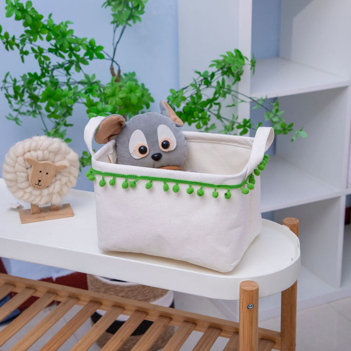 Storage basket with decorative pom-pom trim