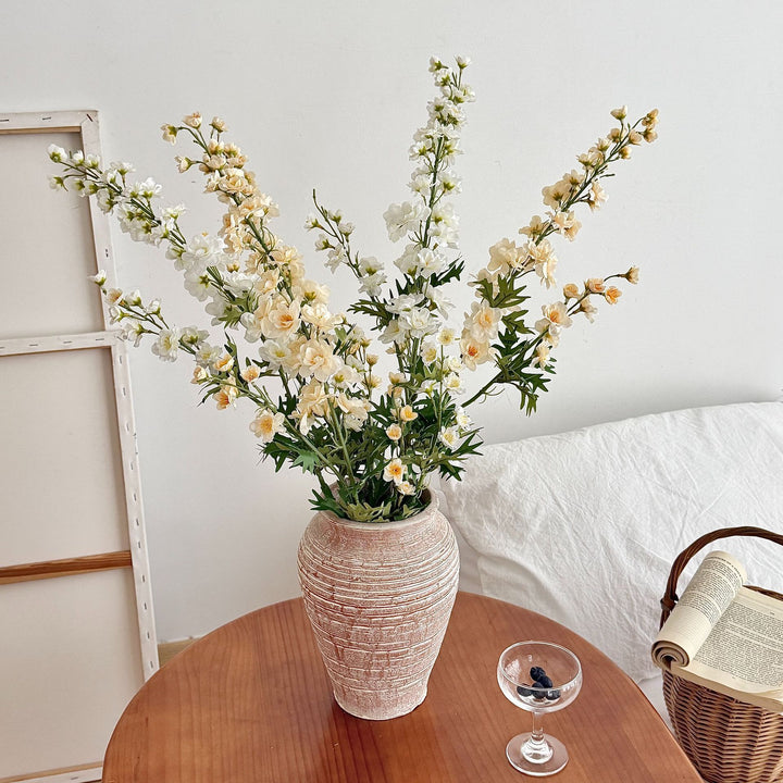 Artificial flower branch with intricately detailed red flowers