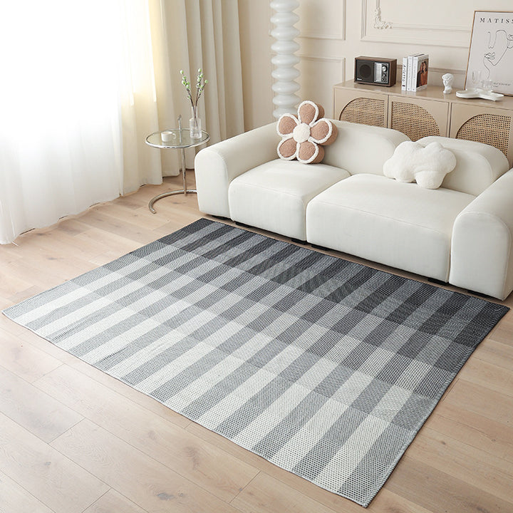Woven living area rug with large check pattern and flat cotton texture