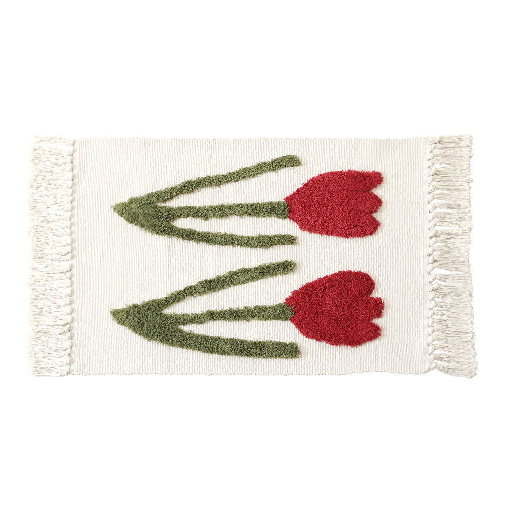 Handwoven cotton bath mat rug with tufted flower appliqué and tassels