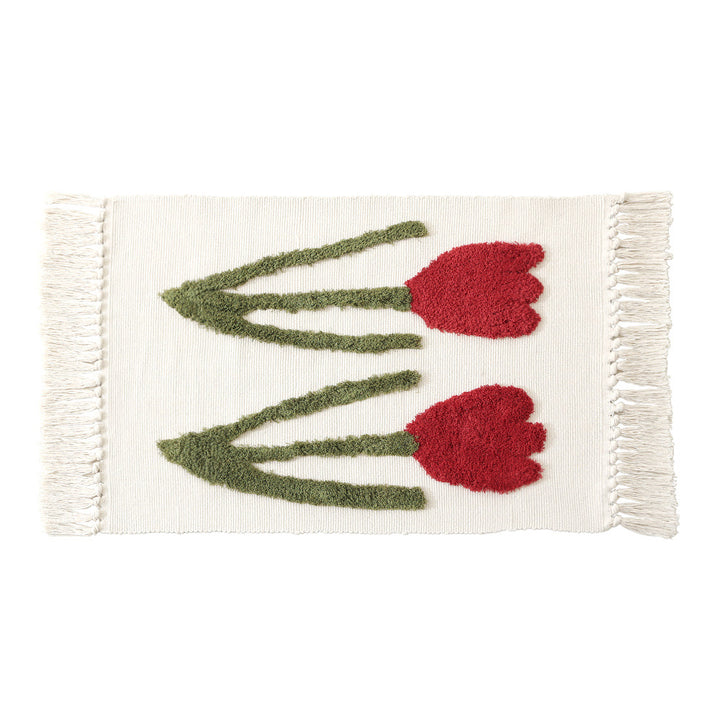 Handwoven cotton bath mat rug with tufted flower appliqué and tassels