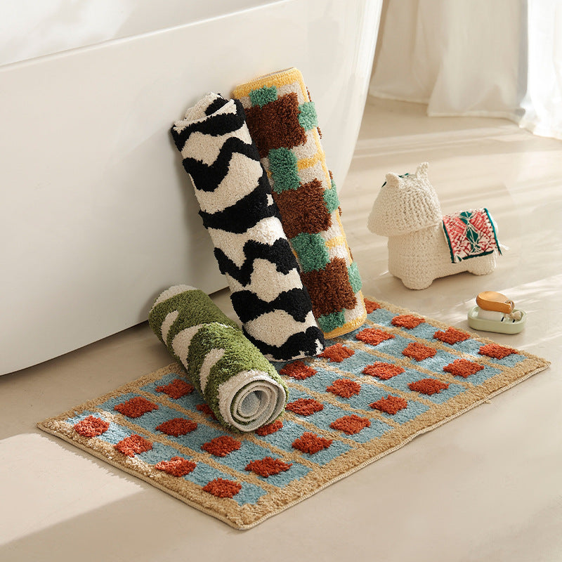 Hand-tufted bathroom bath mat with non-slip backing and textured square relief
