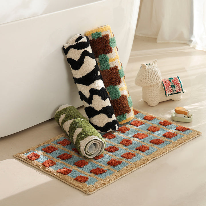 Hand-tufted bathroom bath mat with non-slip backing and textured square relief