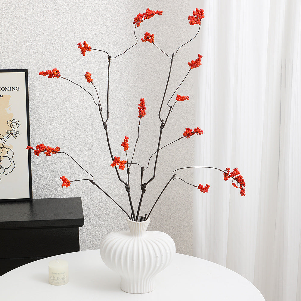 Decorative artificial flower branch with glowing red berries