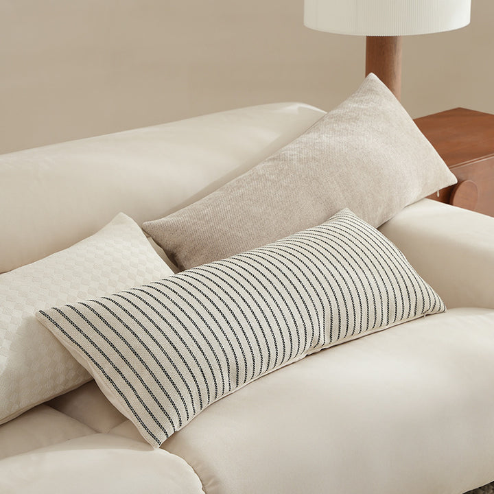 Long rectangular lumbar and neck pillow with textured woven look and concealed zipper