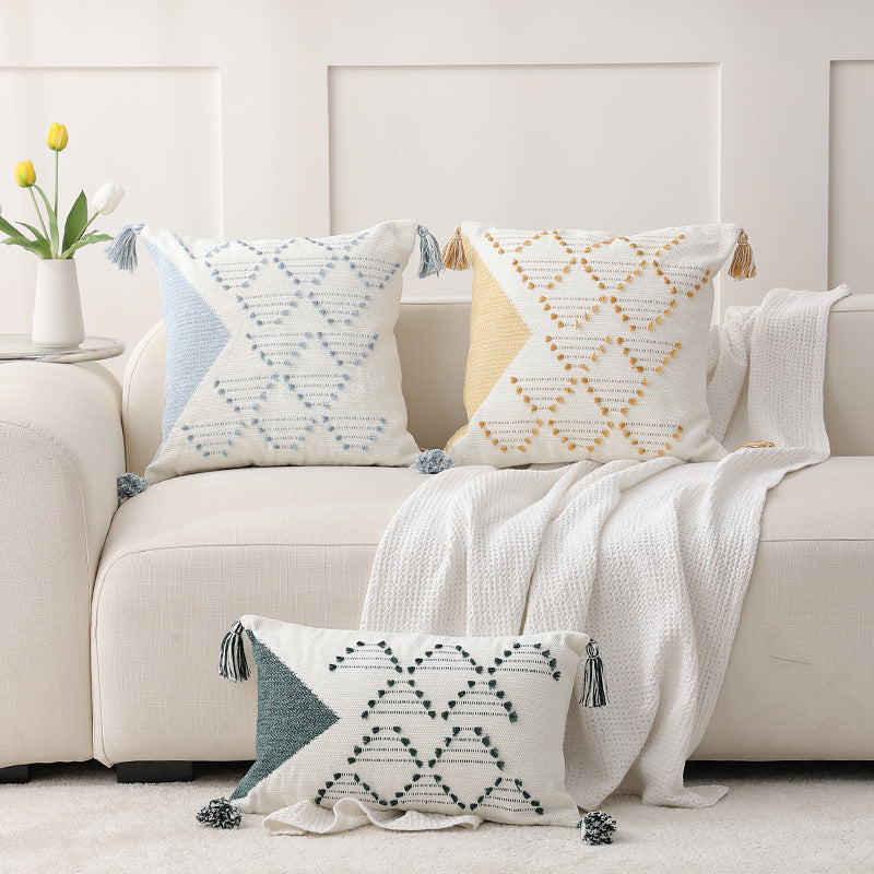 Decorative woven cushion cover with geometric tuft-relief and tassels