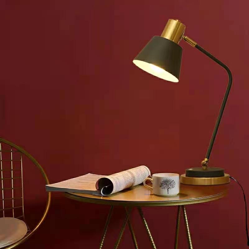 Adjustable metal desk lamp with swivel arm and brass accents