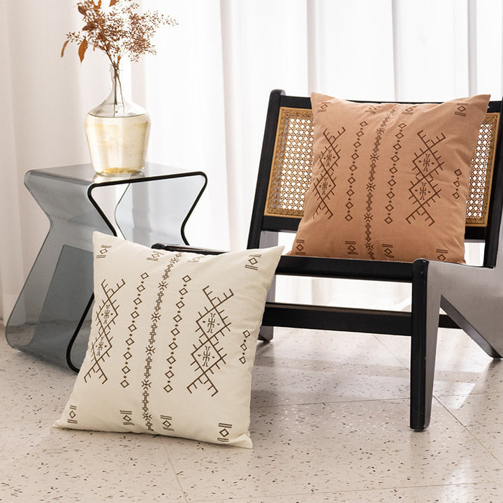 Square decorative cushion with fine relief embroidery in ethnic design and removable cover