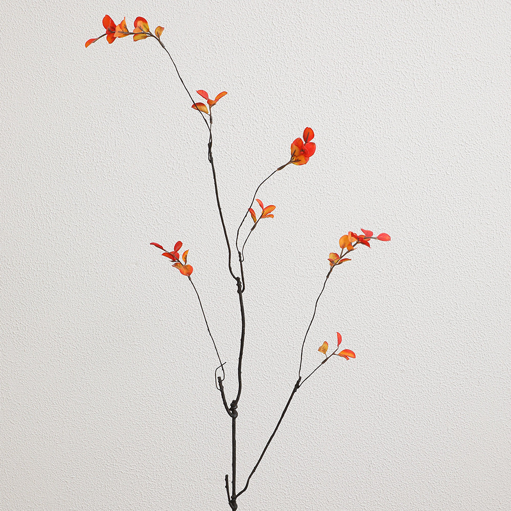 Artificial flower branch with vibrant orange flowers