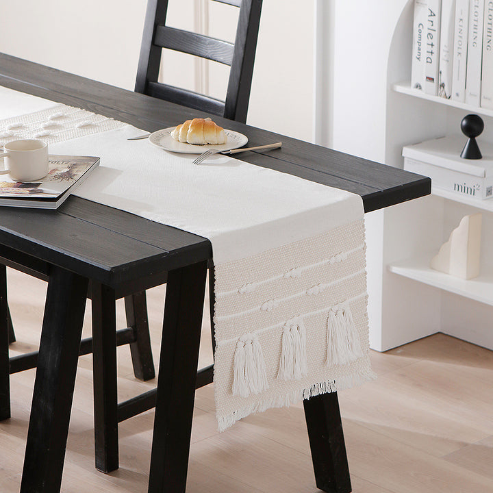 Woven cotton table runner with boho stripes, fringes, and textured woven edge