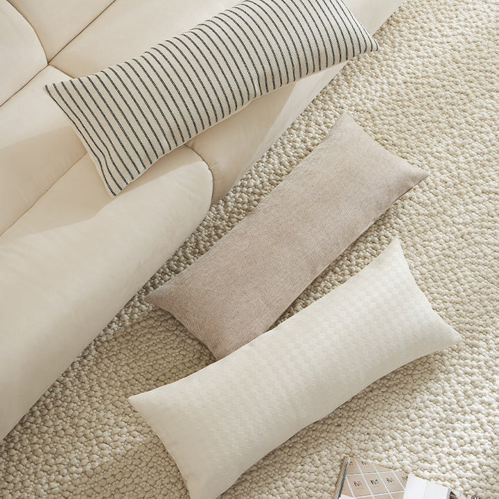 Long rectangular lumbar and neck pillow with textured woven look and concealed zipper