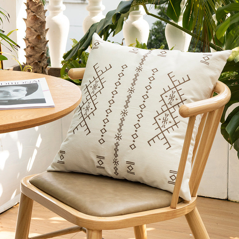 Square decorative cushion with fine relief embroidery in ethnic design and removable cover