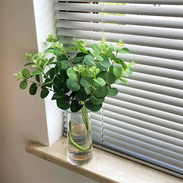 Artificial flowering branch with lifelike leaves and delicate flowers