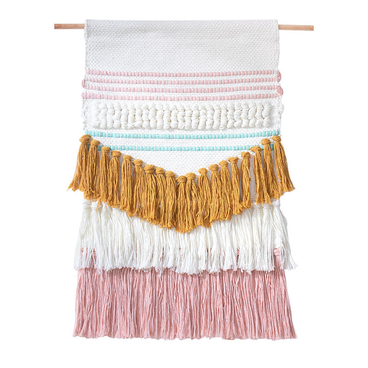 Handwoven wall hanging in boho style with tassels and geometric structure