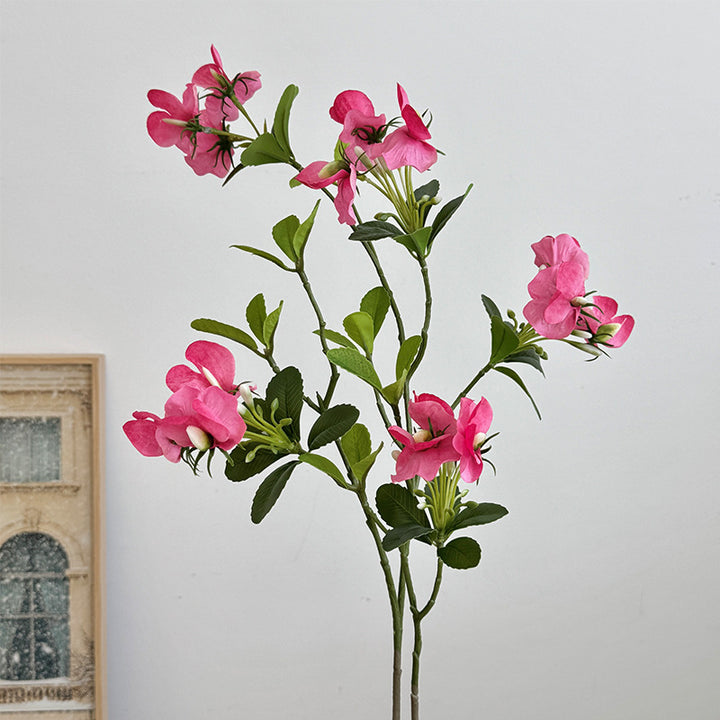 Artificial flower branch with vibrant pink flowers